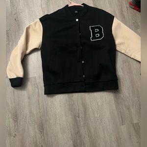 Brown and tan jacket with letter.